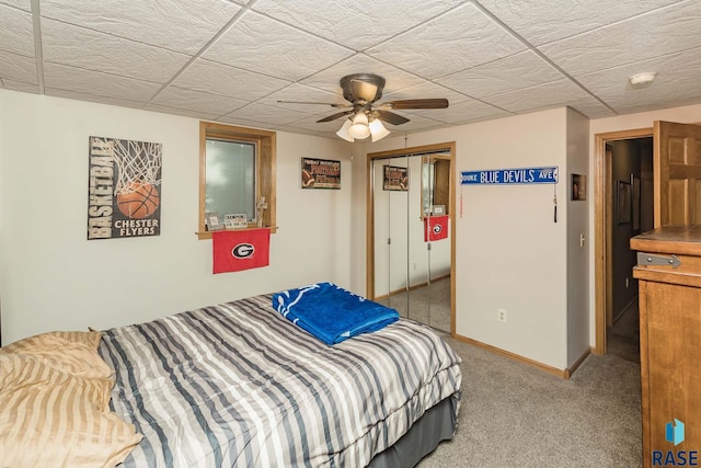 carpeted bedroom with ceiling fan and a closet