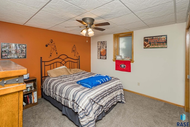 carpeted bedroom with a drop ceiling and ceiling fan