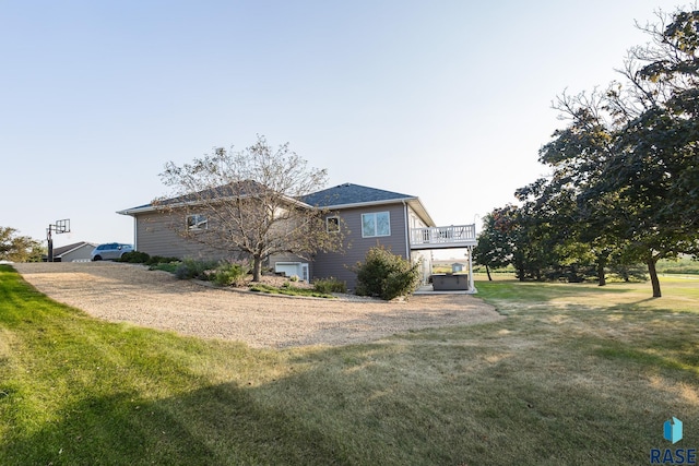 view of property exterior featuring a yard and a deck