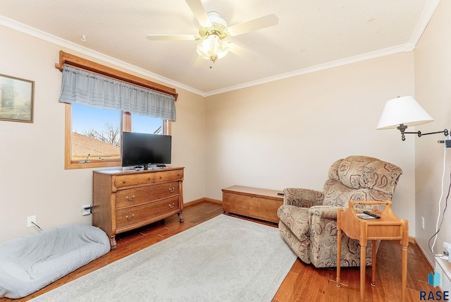 sitting room featuring hardwood / wood-style floors, ornamental molding, and ceiling fan