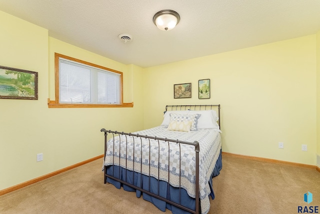 carpeted bedroom featuring a textured ceiling