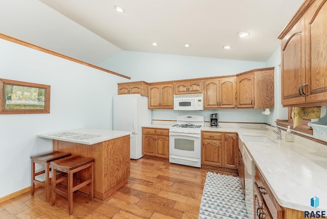 kitchen featuring vaulted ceiling, white appliances, light hardwood / wood-style floors, and sink