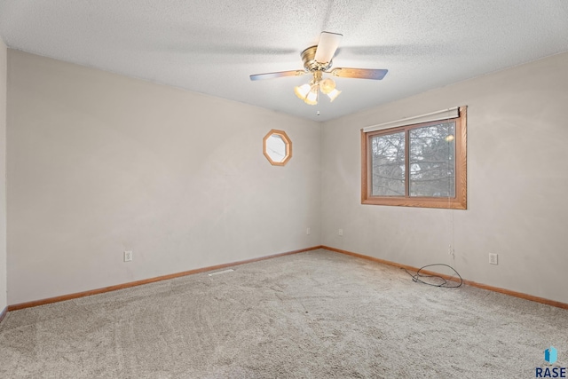 carpeted empty room with a textured ceiling and ceiling fan