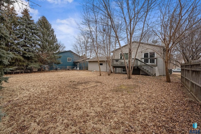 rear view of house featuring a wooden deck