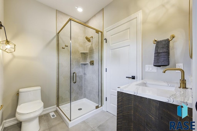 bathroom featuring tile patterned flooring, toilet, a shower with door, and sink