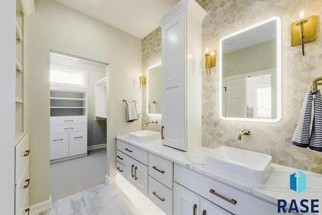 bathroom featuring vanity and decorative backsplash