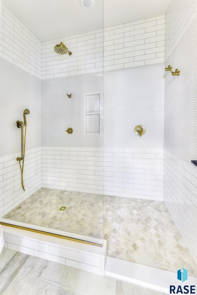 bathroom with a tile shower