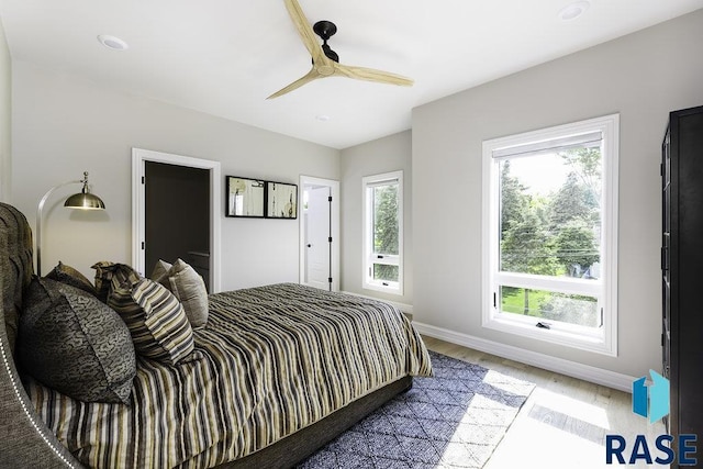 bedroom with ceiling fan and light hardwood / wood-style flooring