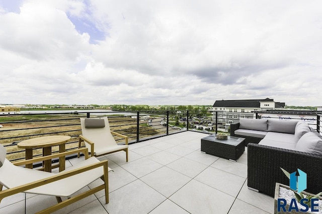 view of patio featuring an outdoor hangout area and a balcony