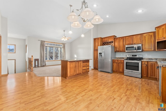 kitchen with appliances with stainless steel finishes, ceiling fan with notable chandelier, high vaulted ceiling, decorative light fixtures, and light hardwood / wood-style flooring