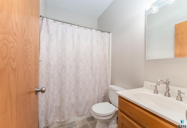 bathroom with vanity, tile patterned floors, and toilet