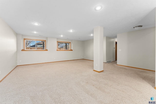 basement featuring light carpet