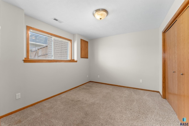 unfurnished bedroom featuring carpet floors and a closet