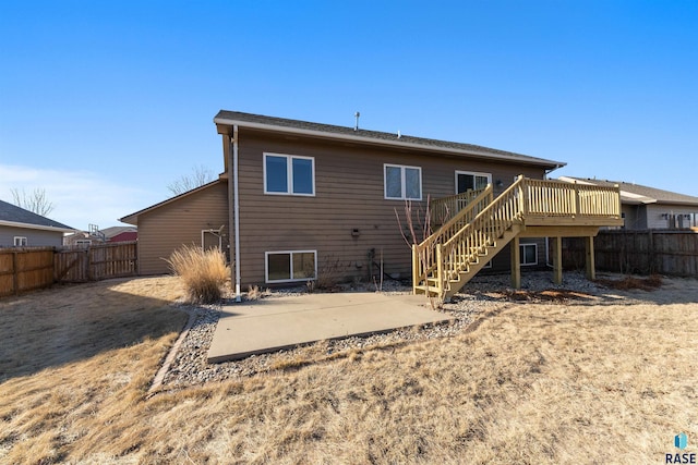 back of house featuring a wooden deck and a patio area