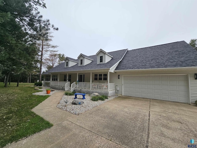 view of front of home with a porch, a garage, and a front lawn