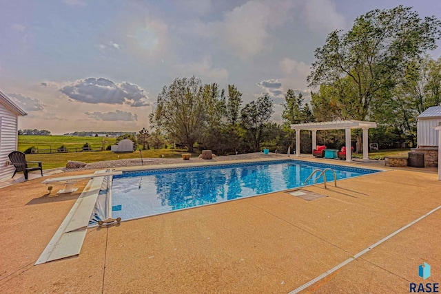 view of swimming pool featuring a pergola, a patio, and a diving board