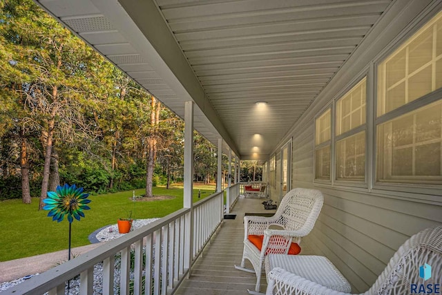 deck featuring a lawn and covered porch