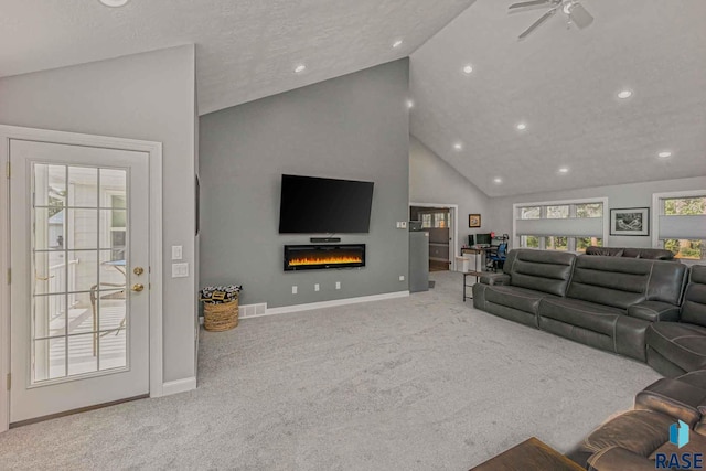 living room featuring ceiling fan, high vaulted ceiling, and light carpet