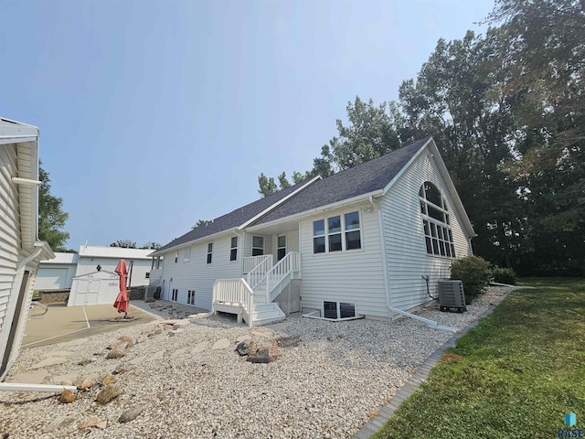 view of front of house featuring a storage shed and central air condition unit