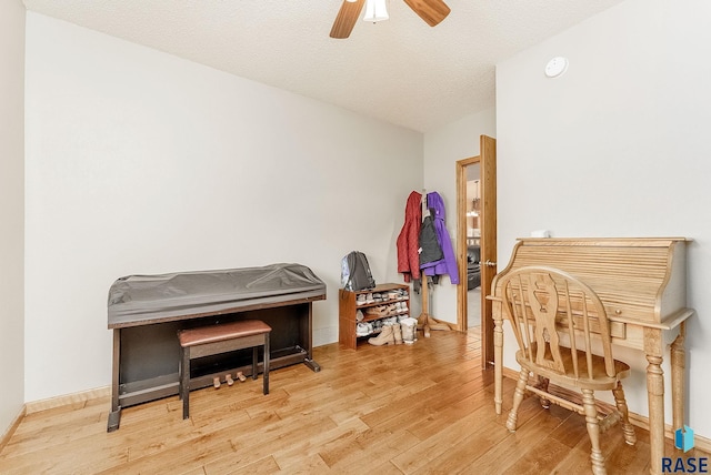 misc room featuring a textured ceiling, light hardwood / wood-style floors, and ceiling fan