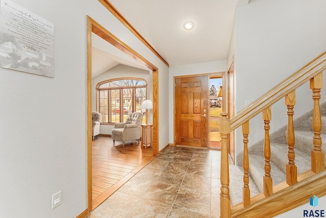 foyer entrance featuring vaulted ceiling