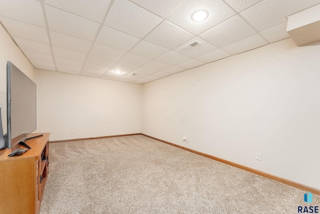 interior space with a paneled ceiling and carpet flooring