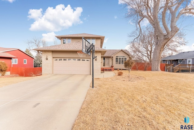 view of front of property featuring a garage and a front lawn