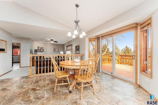 dining space featuring a notable chandelier and vaulted ceiling