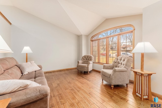 living room featuring light hardwood / wood-style flooring and vaulted ceiling