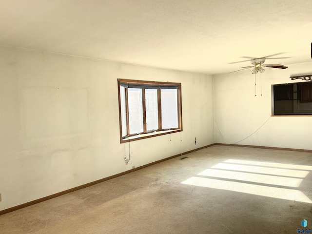 empty room with ceiling fan and light colored carpet