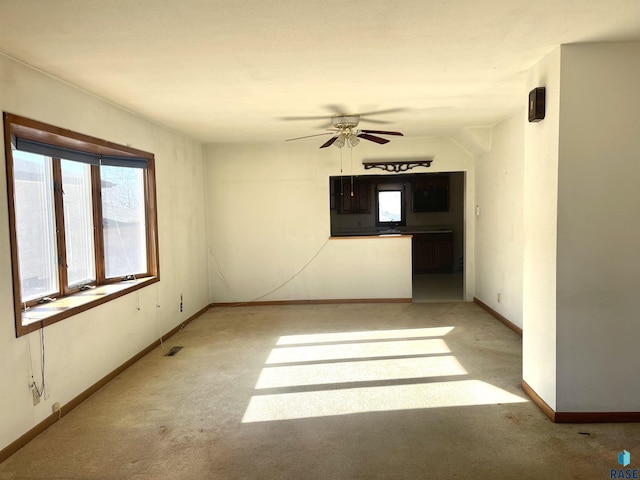 carpeted empty room featuring ceiling fan