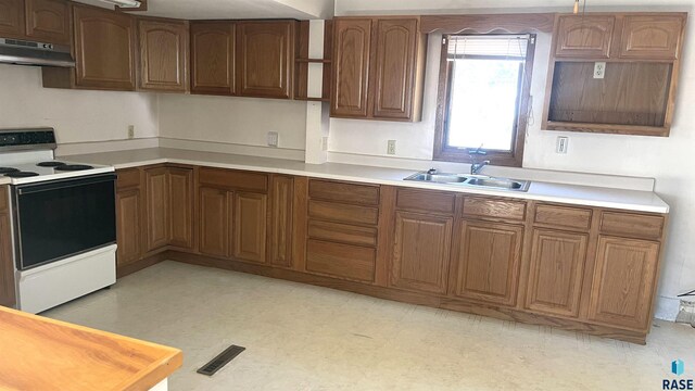 kitchen with electric range oven and sink