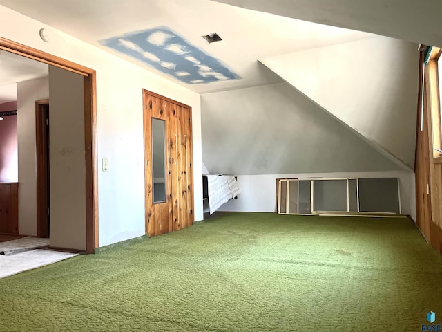 bonus room featuring vaulted ceiling and carpet flooring