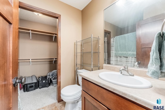 bathroom featuring vanity, curtained shower, and toilet