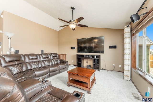 living room featuring lofted ceiling, light colored carpet, and ceiling fan