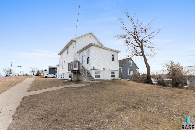 back of house with a lawn