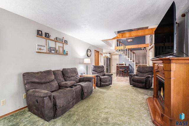 living room featuring carpet floors and a textured ceiling