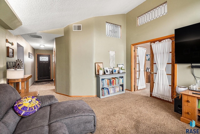 interior space featuring vaulted ceiling, light colored carpet, and a textured ceiling