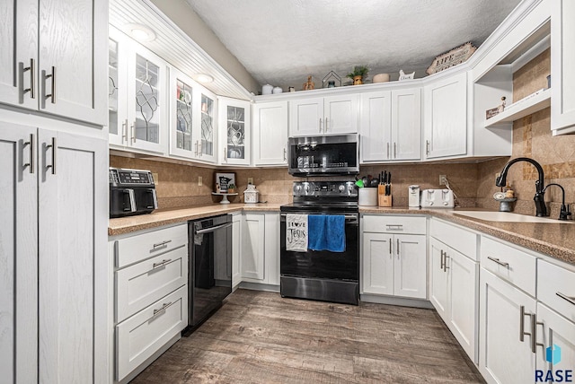 kitchen featuring sink, dark wood-type flooring, white cabinetry, electric range, and black dishwasher