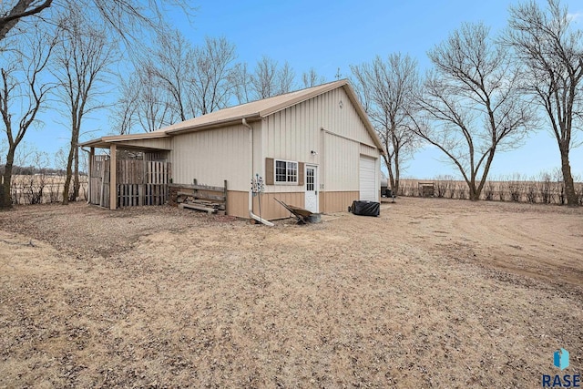 view of side of home with a garage and an outdoor structure