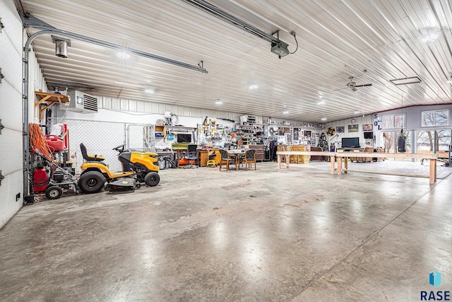 garage featuring a garage door opener and a workshop area