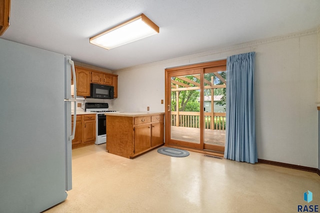 kitchen featuring white appliances and kitchen peninsula