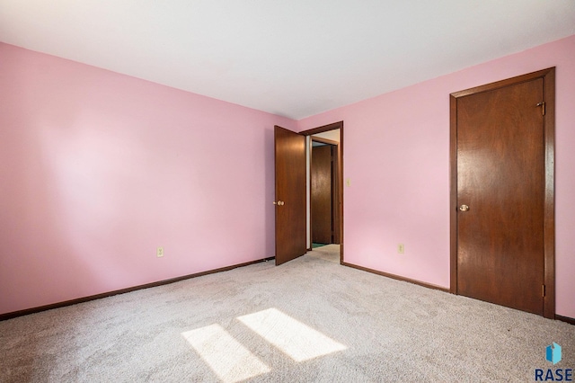 unfurnished bedroom featuring light colored carpet