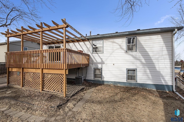 rear view of house with a wooden deck and a pergola