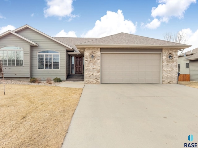 ranch-style home with a garage and a front lawn