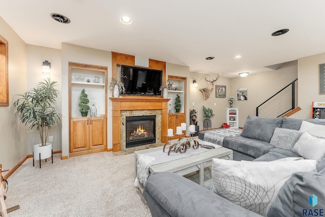 carpeted living room featuring built in shelves and a large fireplace