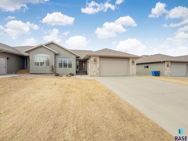 ranch-style home with a garage and a front lawn