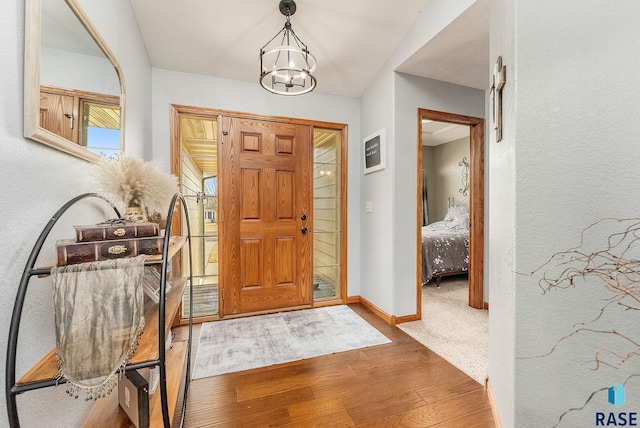 entryway featuring a notable chandelier and wood-type flooring