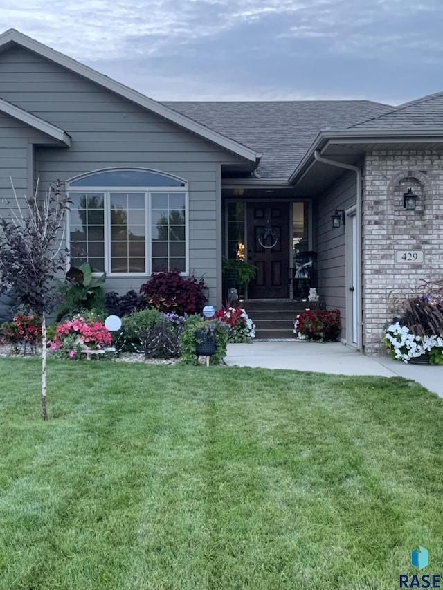 entrance to property with a yard