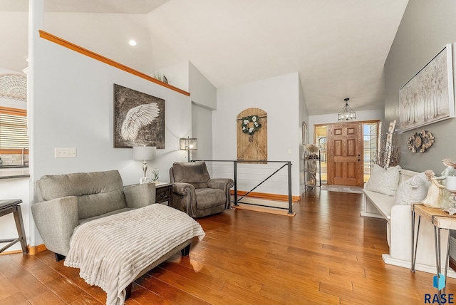 interior space featuring hardwood / wood-style floors and high vaulted ceiling